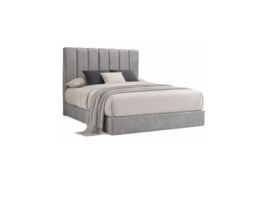 A modern platform bed with a tall, vertically channel-tufted upholstered headboard and matching upholstered base, shown in a light gray fabric. The bed is styled with neutral bedding, including a light gray duvet, dark gray pillows, and a matching gray throw blanket, set against a plain white background.