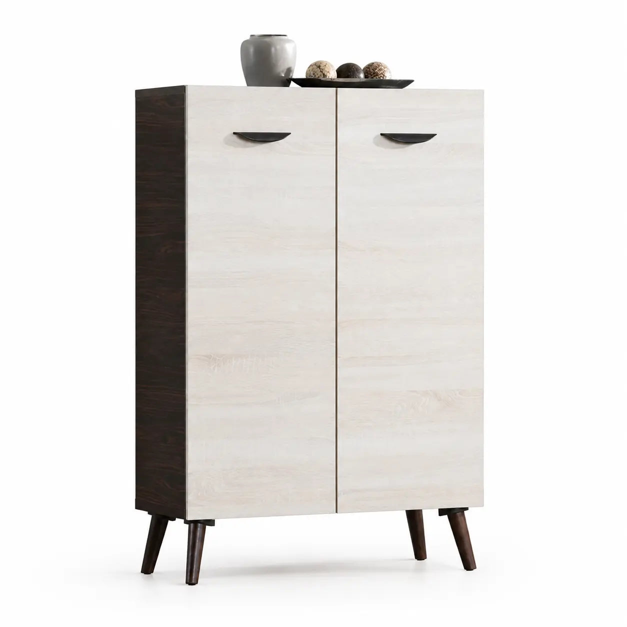 A mid-century modern two-door cabinet with light beige wood grain doors, a dark brown side panel, and tapered dark brown legs, shown on a white background with decorative objects on top.