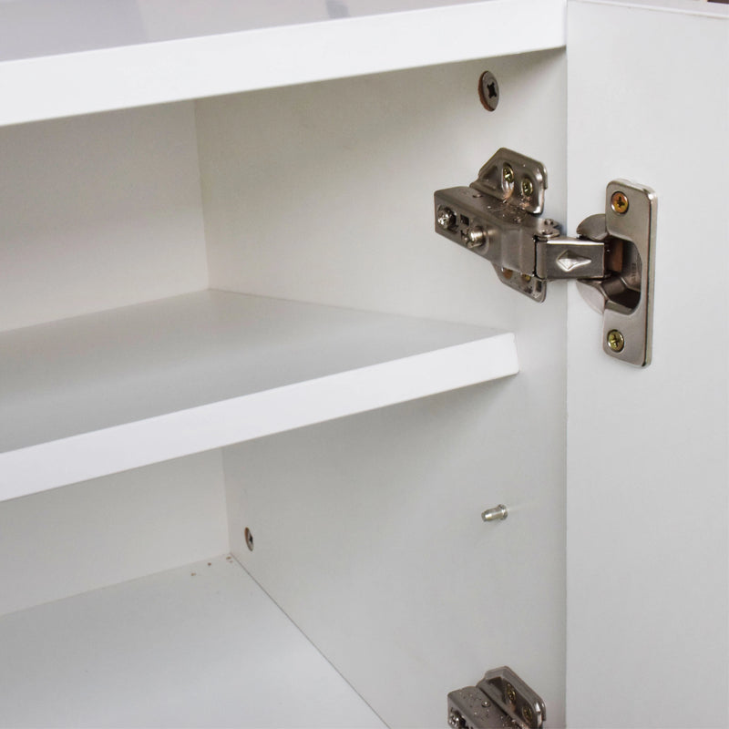 Close-up of a cabinet hinge on a white cabinet door