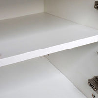 Close-up of a white shelf with a strip light underneath