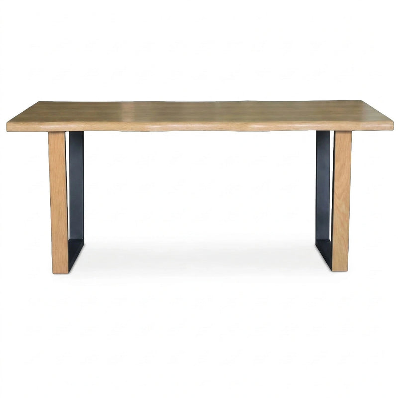 Wooden table with black legs on a white background