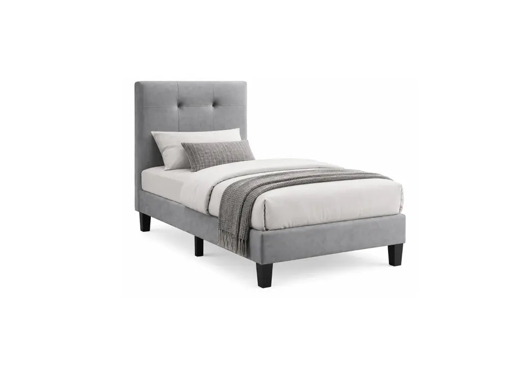 A light gray upholstered bed frame with a tall button-tufted headboard and dark legs, shown with white bedding and a gray throw blanket on a plain white background.