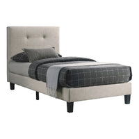 Bed with gray upholstered headboard and checkered bedding on a white background