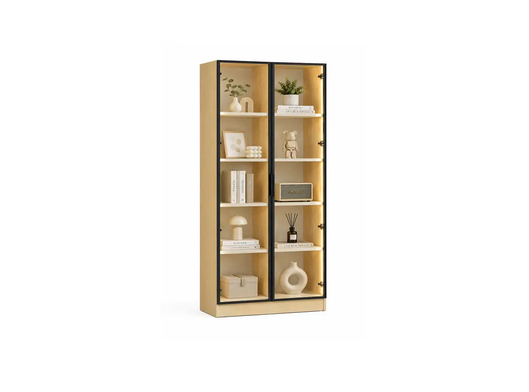 A tall light wood bookcase with two black-framed glass doors and six open shelves, styled with books, vases, and small decor items, shown on a plain white background.
