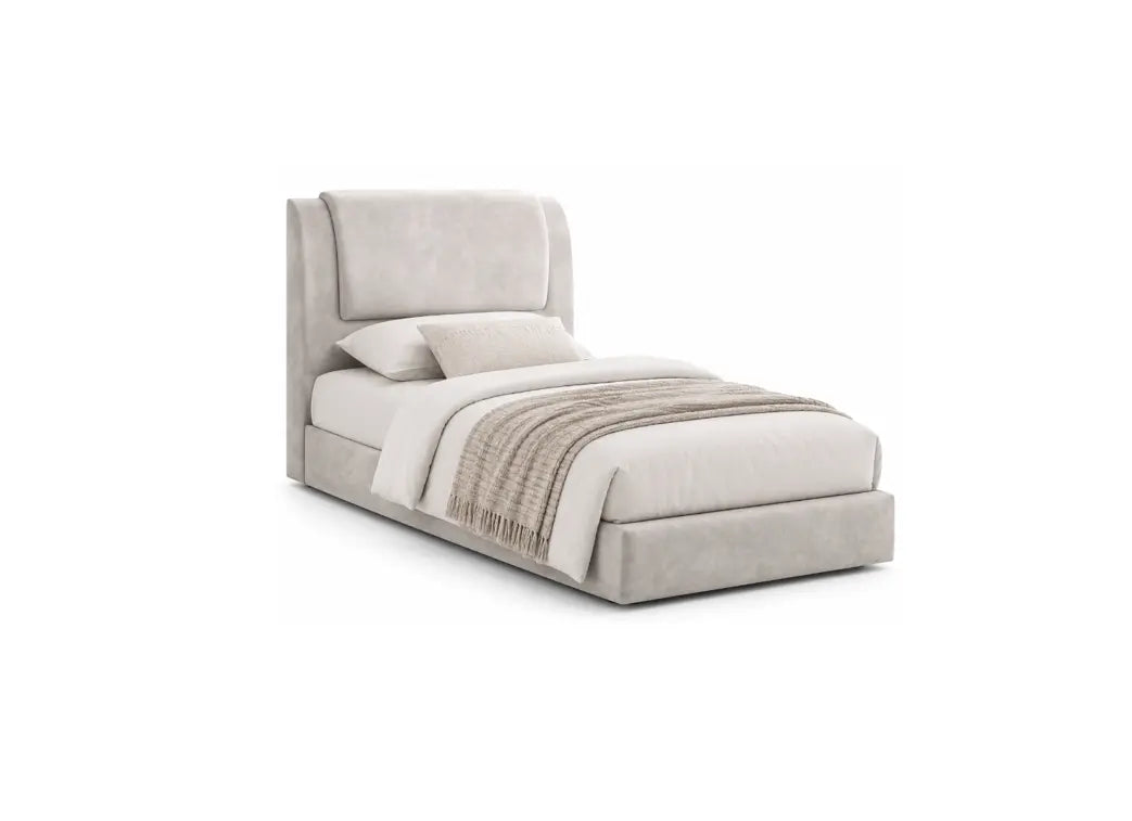 A modern upholstered bed with a tall wingback headboard and low platform base, shown in a light warm gray or greige fabric. The bed is styled with white bedding and a beige textured throw blanket, set against a plain white background.
