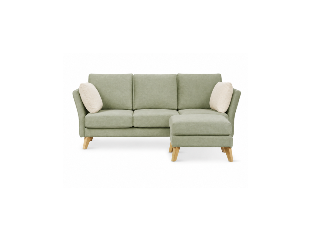 A three-seat sofa with a right-facing chaise lounge, upholstered in a sage green fabric, featuring two cream throw pillows and light-colored wooden legs, shown against a plain white background.