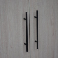 Close-up of a wooden cabinet with black handles