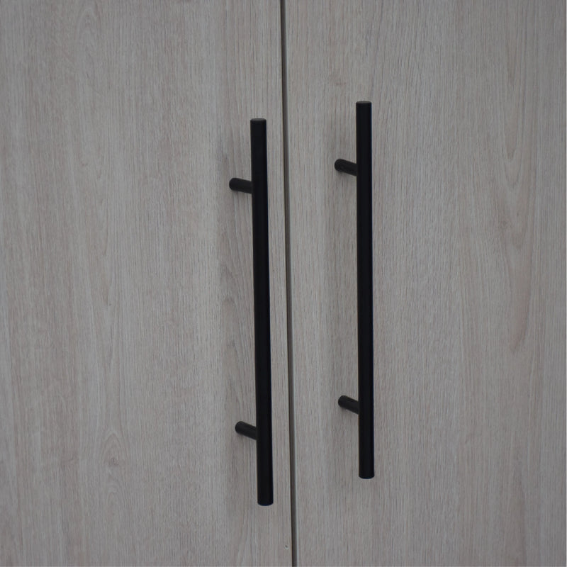 Close-up of a wooden cabinet with black handles