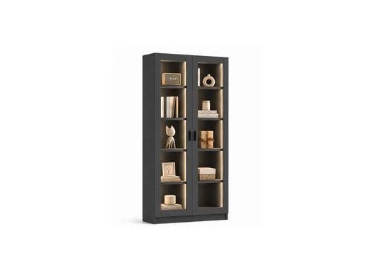 A tall dark gray bookcase with two glass doors and multiple interior shelves, styled with books and decorative objects, shown on a plain white background.