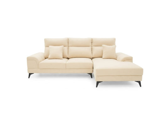 A modern sectional sofa in a light cream or beige fabric, featuring a left-facing armrest, a three-seat back, two matching throw pillows, and a right-facing chaise lounge. The sofa is supported by slim black metal legs and is photographed against a seamless white background.