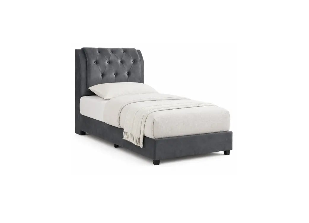 A dark gray upholstered bed frame with a tall button-tufted headboard, shown with white bedding and a light beige throw blanket on a plain white background.