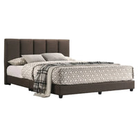 Bed with brown upholstered headboard and geometric bedding on a white background