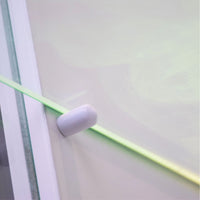 Close-up of a white cylindrical object on a green and gray background