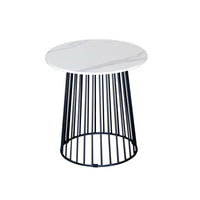 Small round table with a white marble top and black metal base on a white background