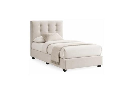 A single bed with a tall, tufted upholstered headboard and matching upholstered base, shown in a light beige or cream fabric. The bed is dressed with matching pillows, a folded duvet, and a folded throw blanket, and is photographed against a solid white background.