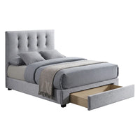 Gray upholstered bed with tufted headboard and open drawer on a white background