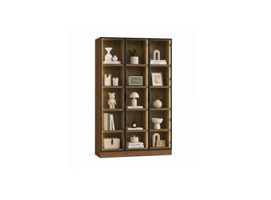A tall wooden bookcase with multiple open shelves, styled with neutral-toned decor including vases, books, a small plant, a lamp, and framed art, shown against a plain white background.