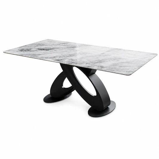 A modern rectangular dining table with a white and gray marble-patterned top and a sculptural black metal base, shown on a plain white background.