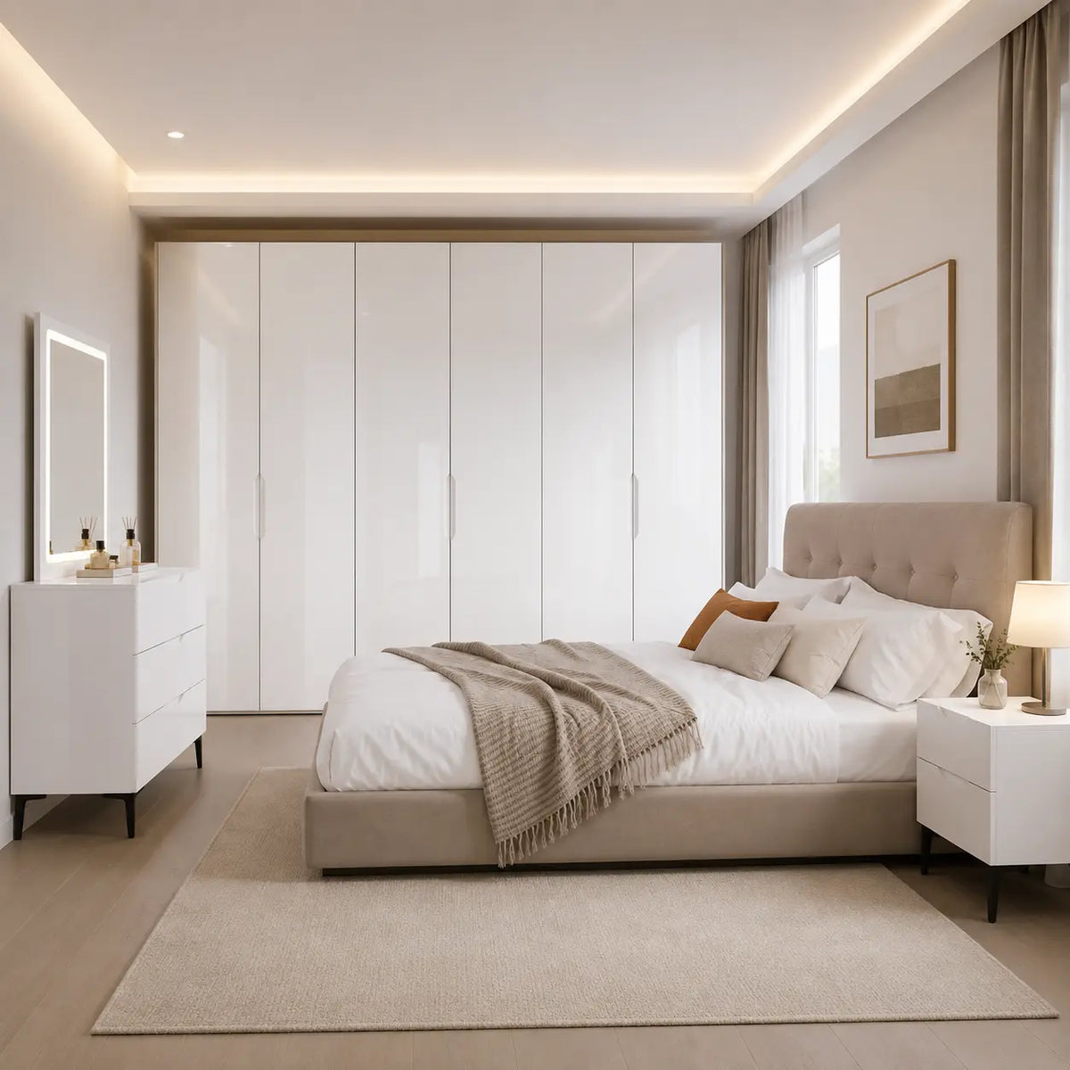 A modern bedroom featuring a large white high-gloss wardrobe, a beige upholstered bed with white bedding and a textured throw blanket, a matching white nightstand with a lit lamp, and a white dresser with an illuminated mirror, all arranged on a light beige rug.