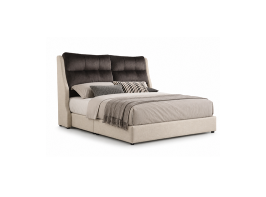 An upholstered bed with a tall tufted dark gray headboard and a low beige platform base, styled with neutral gray and beige bedding and pillows on a white background.