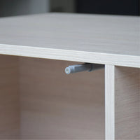 Close-up of a wooden shelf with a metal bracket