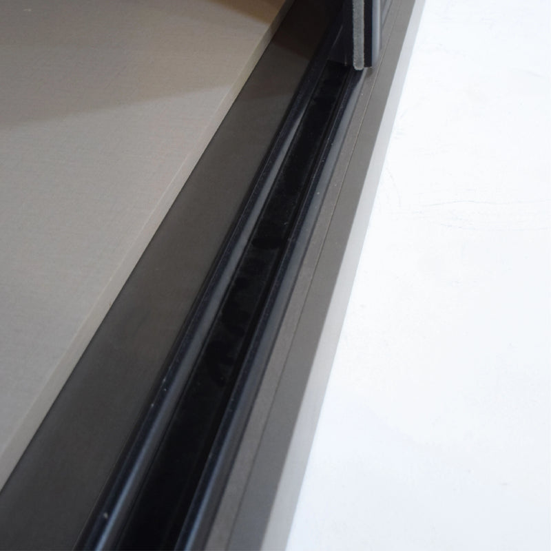 Close-up of a car window with a black frame on a white background