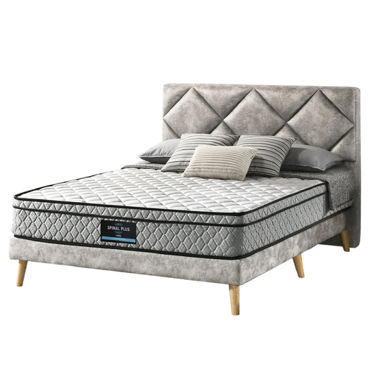 Gray upholstered bed with a mattress and pillows on a white background