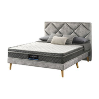 Gray upholstered bed with tufted headboard and mattress on a white background