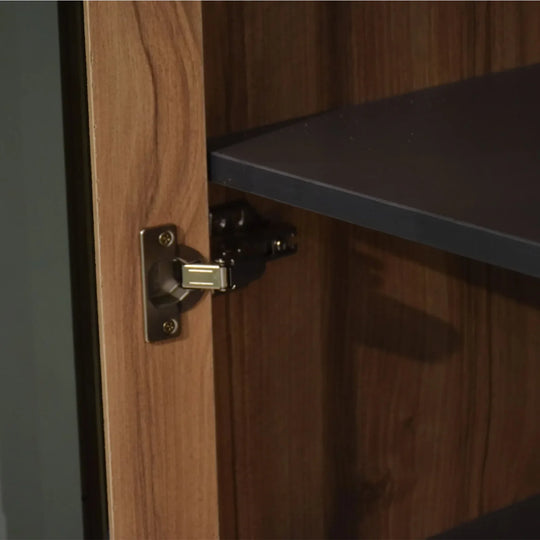 Wooden cabinet with a black shelf and brass hinge
