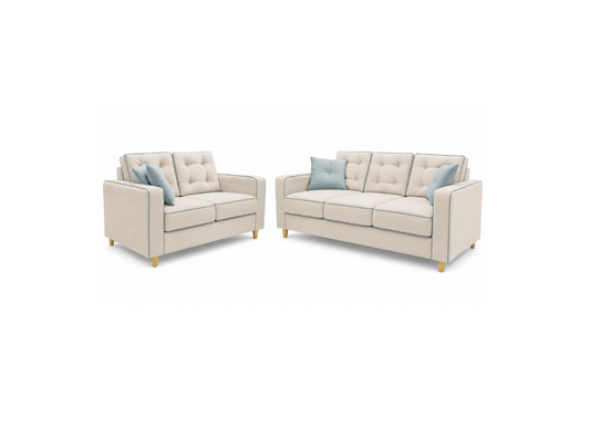 A matching upholstered loveseat and sofa set in a light warm beige fabric, each styled with two light blue accent pillows, shown on a plain white background.