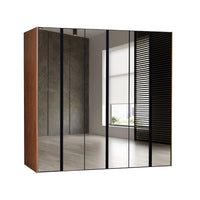 Modern wardrobe with glass doors in a room with a window.
