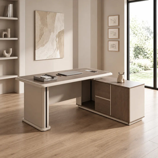 A modern L-shaped office desk with a light beige top and cream-colored legs, paired with a matching side cabinet featuring wood-grain doors and drawers, set in a bright, contemporary home office.
