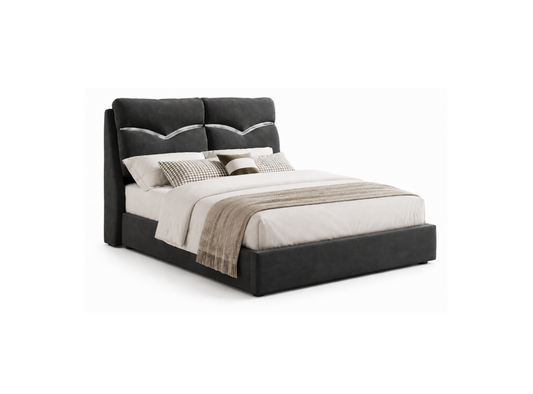 A modern platform bed with an upholstered dark gray headboard and footboard, styled with white bedding, patterned accent pillows, and a beige throw blanket, shown on a plain white background.