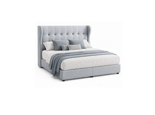 A light gray upholstered bed with a tall button-tufted headboard, shown with white bedding, gray pillows, and a draped gray throw blanket on a plain white background.