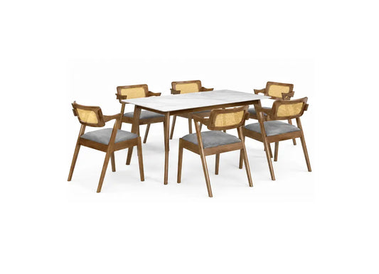 A 7-piece dining set featuring a rectangular white marble-top table with a medium brown wooden frame, surrounded by six matching armchairs with woven cane backrests and gray upholstered seats, shown on a plain white background.