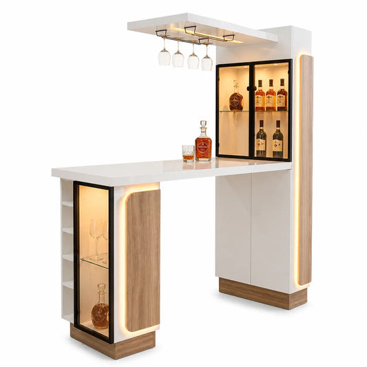 A modern bar cabinet with a white countertop and white side panels, accented by warm wood-grain bases and black-framed glass shelves. Integrated LED lighting illuminates the shelves and bar counter, with hanging glass holders on the top shelf and bottles displayed inside.