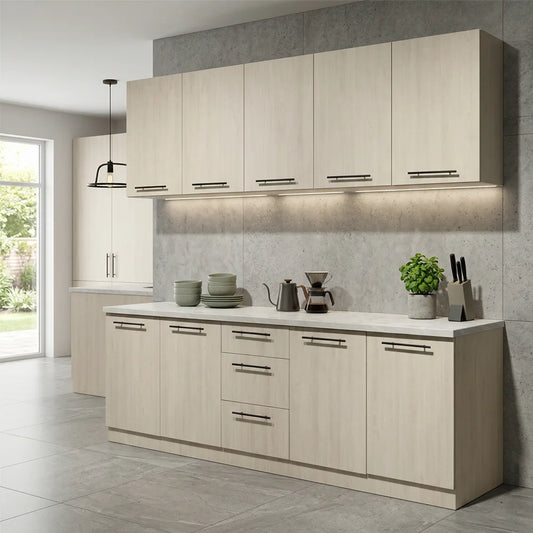 A modern kitchen cabinet set with light beige wood-grain doors, silver bar handles, and a white countertop, shown in a staged kitchen environment with gray tiled floors and backsplash.