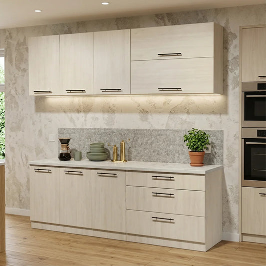 A modern kitchen cabinet set with light wood grain doors and silver bar handles, installed against a textured gray backsplash and white countertop