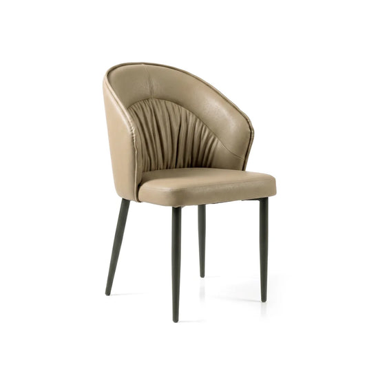 A modern accent chair with a curved backrest upholstered in taupe leather, featuring vertical channel tufting on the backrest and dark gray tapered legs, shown