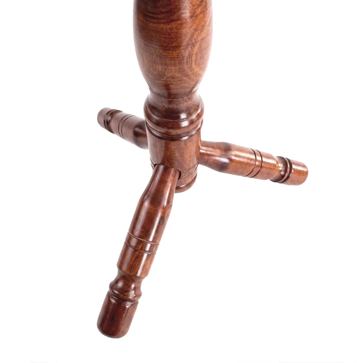 Close-up of a dark brown wooden cloth stand base with three turned legs and decorative ring details, isolated on a white background.