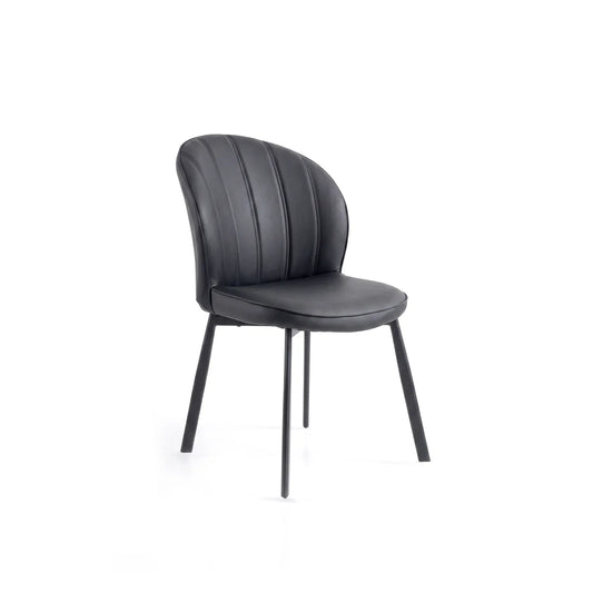 A modern black dining chair with a curved, vertically channel-tufted faux leather backrest and a matching padded seat, supported by slim black metal legs, shown against a plain white background.