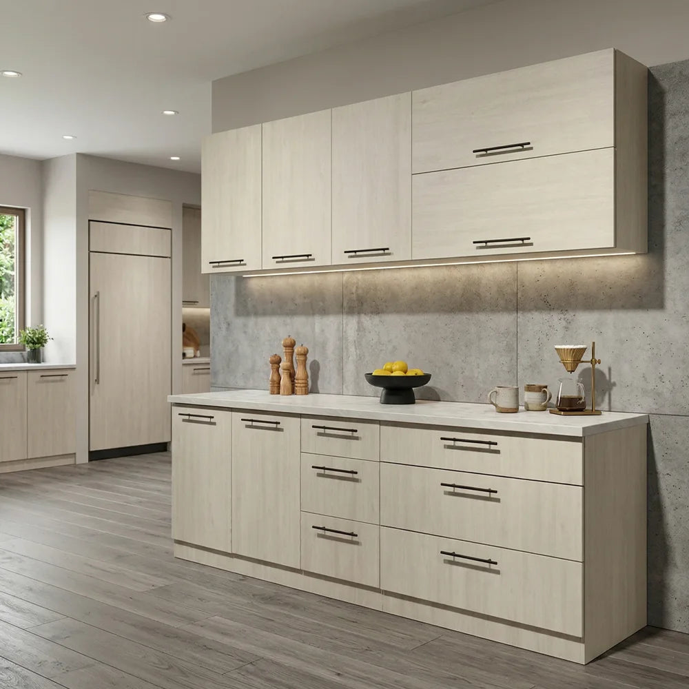 A modern kitchen cabinet set in a light beige woodgrain finish with sleek black horizontal bar handles, set against a gray concrete-look backsplash and gray wood-look flooring