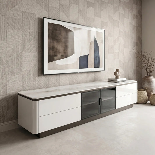 Modern living room with a white TV stand, framed abstract art, and decorative items