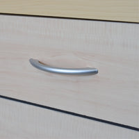 Metallic handle on a wooden surface