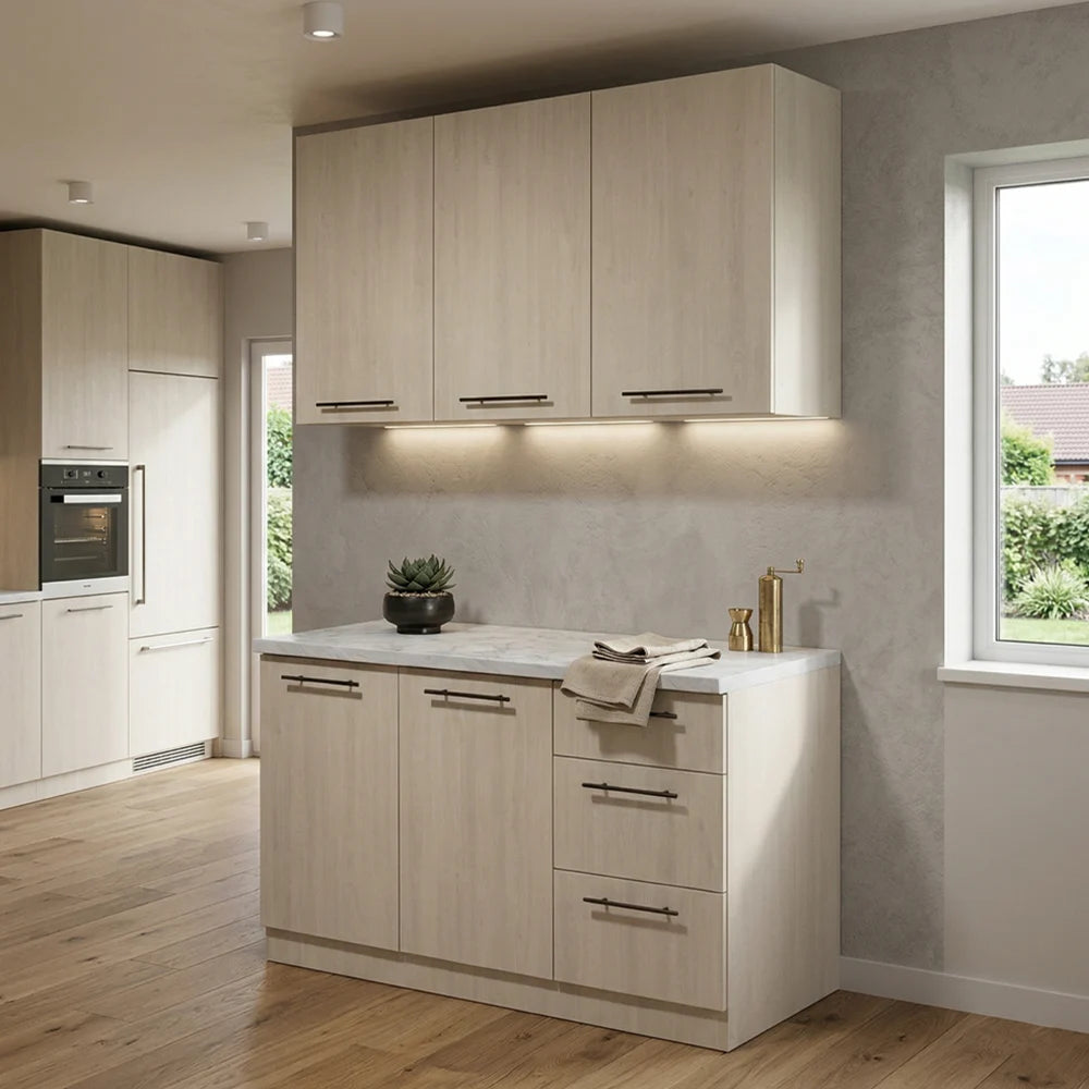 A modern kitchen island with light wood grain cabinets, a white countertop, and dark metal handles, set in a contemporary kitchen with wood floors and gray walls.