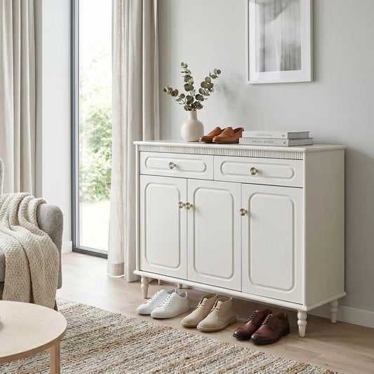 White sideboard with shoes and decor in a living room setting