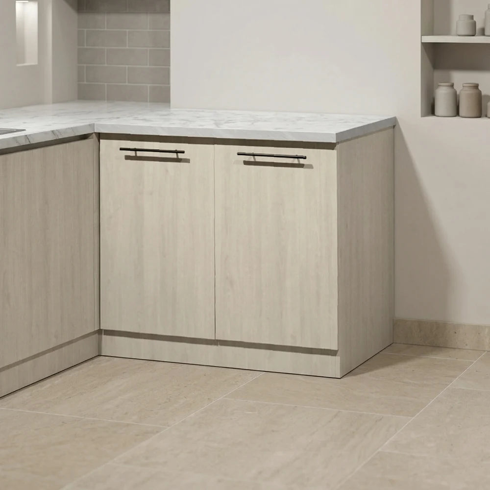 Light wood kitchen cabinets with a white marble countertop, set in a modern kitchen with beige tile flooring and backsplash.