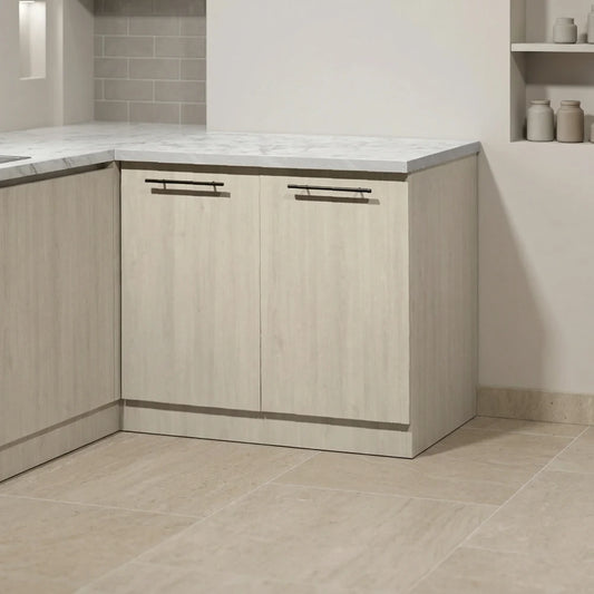 Light wood kitchen cabinets with a white marble countertop, set in a modern kitchen with beige tile flooring and backsplash.