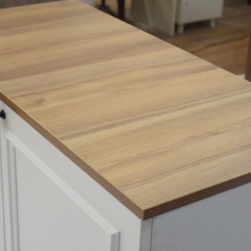 Wooden countertop on a kitchen island with blurred background