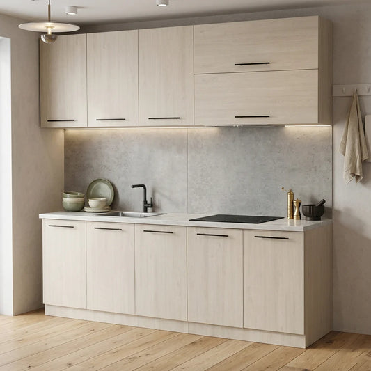A modern kitchen cabinet set with light beige wood-grain doors, a textured gray backsplash, a white countertop, and black hardware, shown in a styled interior with wood flooring